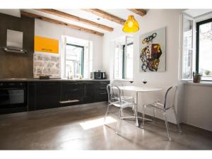 a kitchen with a table and chairs in a room at Apartment Diocletian Pearl in Split