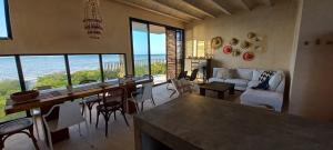 a living room with a view of the ocean at Casa Manuela: Espectacular villa al frente del mar in Sisal