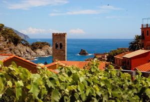 a building with a tower in the middle of the ocean at Hotel Marina in Monterosso al Mare