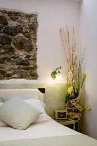 a bedroom with a white bed and a stone wall at Hotel Marina in Monterosso al Mare