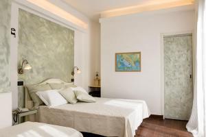a bedroom with two beds and a painting on the wall at Hotel Marina in Monterosso al Mare