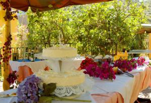 a three layer cake sitting on a table with flowers at Hotel Marina in Monterosso al Mare