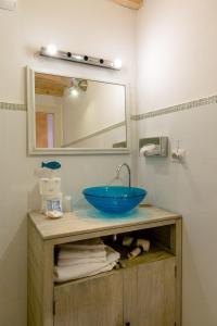 a bathroom with a blue sink and a mirror at Hotel Marina in Monterosso al Mare