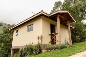 a small house on the side of a hill at Chalés Vale da Lua in Gonçalves