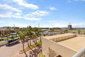 a view of a street with palm trees and a bus at Perfect condo, room for everyone! Beachfront resort in South Padre Island