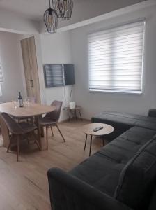 a living room with a couch and a table at Apartmani NIX VIR in Jahorina
