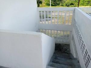 a stairway with a white railing and a stair case at Casa de Recreo - Vacation House in Honda