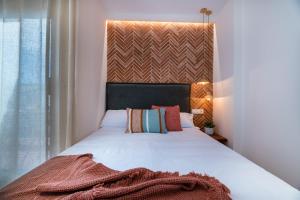 Ein Bett oder Betten in einem Zimmer der Unterkunft VESTAL Suites DOMO