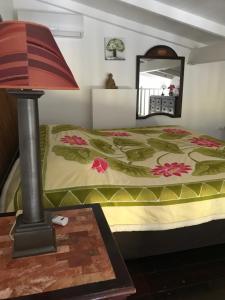 a bedroom with a bed and a table with a lamp at Joli Duplex à St Francois in Saint-François