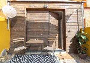 a patio with two chairs and a swing at Tiny House By Casa Maui in Corralejo