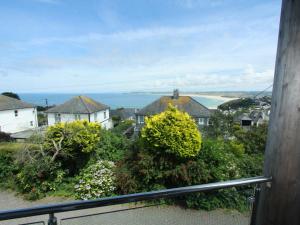 a view of the ocean from the balcony of a house at Shamal in Carbis Bay