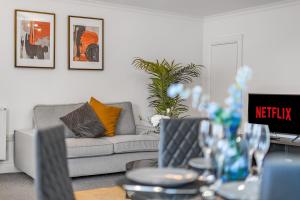 a living room with a couch and a table at Modern, City Centre -2 Bedroom Apartments in Reading