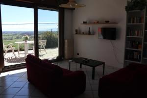 a living room with a couch and a table at Appartamento in villa con vista Monviso in Piossasco