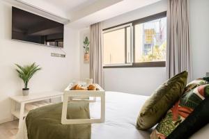 a living room with a bed and a table with a side table at Playa del Pirata IKiGai in San Bartolomé