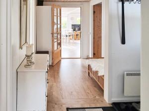 a living room with a hallway with a table at 7 person holiday home in Højslev-By Traum in Højslev +28 photos