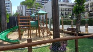 a park with a playground with chairs and a slide at Maravilhoso Apartamento na Beira Mar in Fortaleza