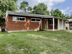 a home with a brick house with a yard at Spacious Ranch Queen Beds 15 min Downtwn in Cincinnati