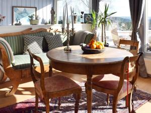 a table with a bowl of fruit on it in a living room at Holiday home NESØYA in Sandvika