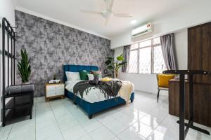 a bedroom with a blue bed and a chair at Kelana Puteri by JustStay 7mins walking to Paradigm Mall in Petaling Jaya