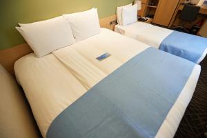 Łóżko lub łóżka w pokoju w obiekcie Days Hotel by Wyndham Seoul Myeongdong