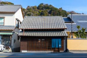 a building with a metal roof on a street at Machihaku 456 in Shizuoka