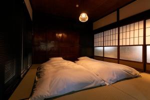 a bedroom with two white pillows on a bed at Machihaku 456 in Shizuoka