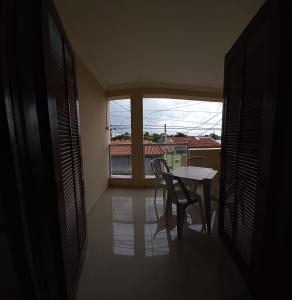 a room with a table and chairs and a window at Santa Helena Pousada in Cachoeira Paulista +81 photos