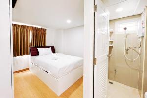 Postel nebo postele na pokoji v ubytování PT Grand Hotel