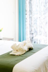 Postel nebo postele na pokoji v ubytování Bohol Cattleya Resort