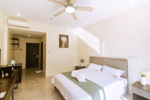 Postel nebo postele na pokoji v ubytování Bohol Cattleya Resort