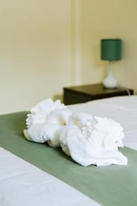 a pile of white towels sitting on a bed at Bohol Cattleya Resort in Panglao Island