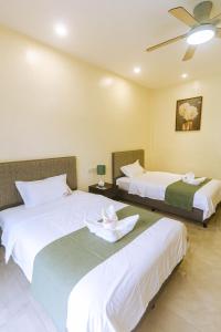 Postel nebo postele na pokoji v ubytování Bohol Cattleya Resort