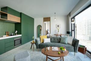 a living room with a couch and a table at basePLUS-BINJIANG Serviced Apartment in Shanghai