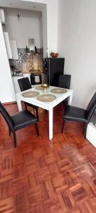 a dining room with a white table and two chairs at La tesoriera in Turin