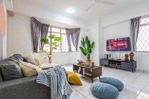 a living room with a couch and a tv at Kelana Puteri by JustStay 7mins walking to Paradigm Mall in Petaling Jaya