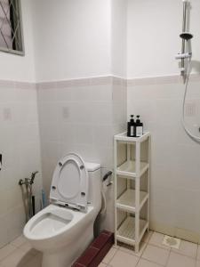 a bathroom with a toilet with the seat up at Kelana Puteri by JustStay 7mins walking to Paradigm Mall in Petaling Jaya