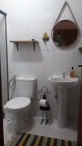 a bathroom with a toilet and a sink at POUSADA CHALÉS DA GROTA de SÃO PEDRO DA SERRA- NOVA FRIBURGO in Nova Friburgo