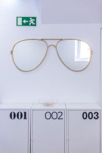 a pair of glasses sitting on top of a table at Dude Beach Hostel in Figueira da Foz