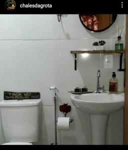 a white bathroom with a sink and a toilet at POUSADA CHALÉS DA GROTA de SÃO PEDRO DA SERRA- NOVA FRIBURGO in Nova Friburgo