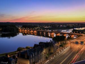 a bridge over a river next to a city at Appartement panoramique au centre de Moulins avec terrasse, 2 chambres, et équipements modernes - FR-1-489-412 in Moulins