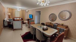 a living room with a table and chairs and a living room at شقة انور المفتى للعائلات فقط 113 in Cairo
