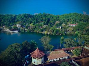 an aerial view of a house on a lake at The Lake Round Guest House in Kandy