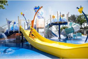 a water park with a yellow slide in the water at Discovery Parks - Forster in Tuncurry