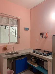 a kitchen with a sink and a counter top at Araliya Suite in Nugegoda +9 photos