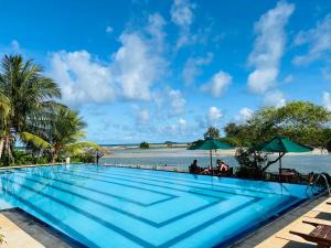 a swimming pool with a view of the ocean at Bay Beach Hotel in Nilaveli