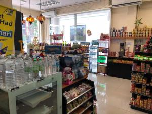 a store filled with lots of bottles of water at The Room Hotel in Miri