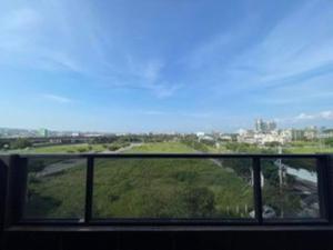 a view of a green field from a window at FengJia Pleasure Life 1 in Taichung