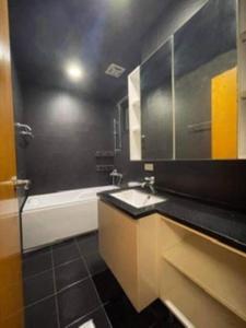 a bathroom with a sink and a bath tub at FengJia Pleasure Life 1 in Taichung