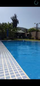 una gran piscina azul con agua azul en Nuestro Quincho en La Rioja