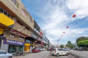 a city street with cars parked on the street at Swing & Pillows - PJ SS2 in Petaling Jaya